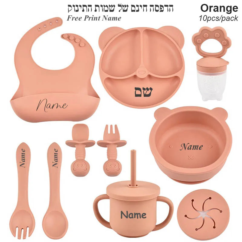 Orange baby utensil set with various items on a white background