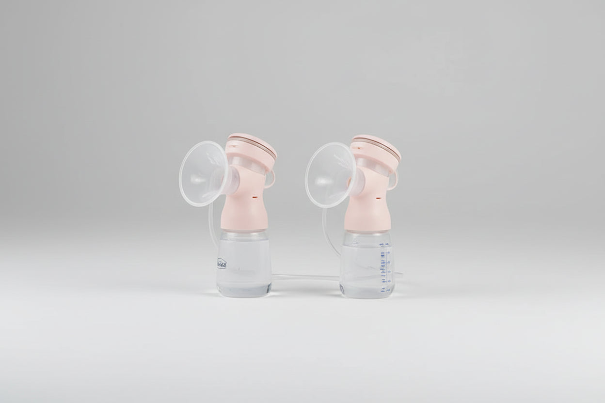 pink breast pump on a grey background