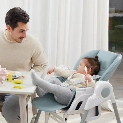 Man and child using a baby high chair indoors