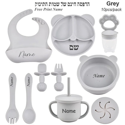 Gray baby utensil set with customizable name on a white background