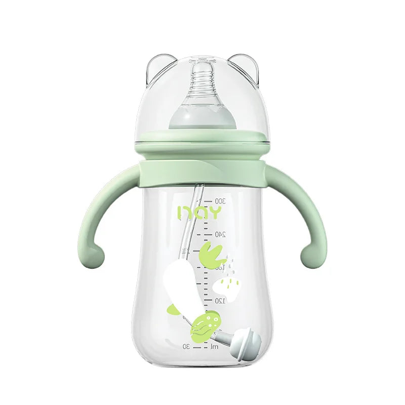 Green baby bottle with handles on a white background