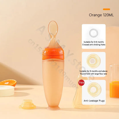 Orange baby bottle with feeding spoon on a beige background