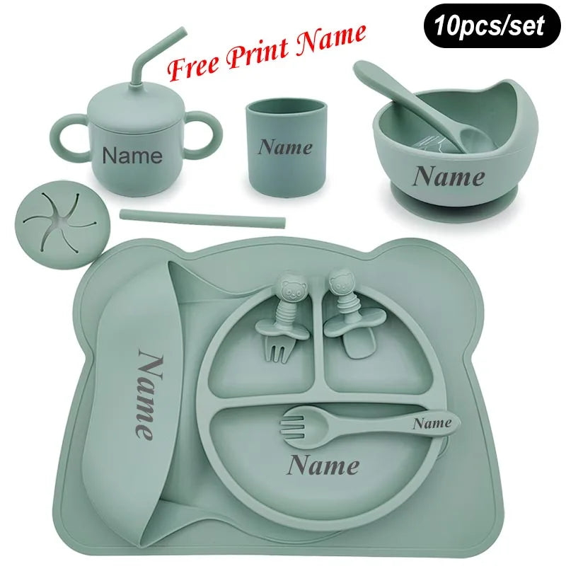 Children's silicone dining set with various utensils and a tray on a white background.