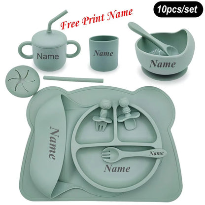 Children's silicone dining set with various utensils and a tray on a white background.