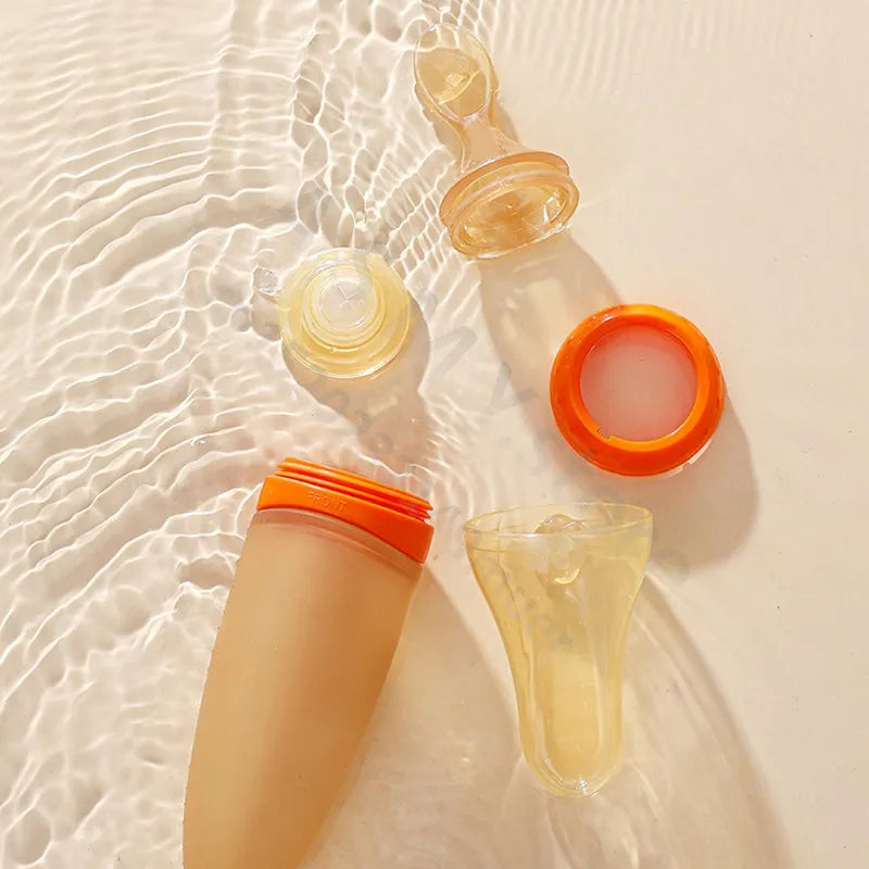 Sunscreen bottles with orange caps on a sandy surface