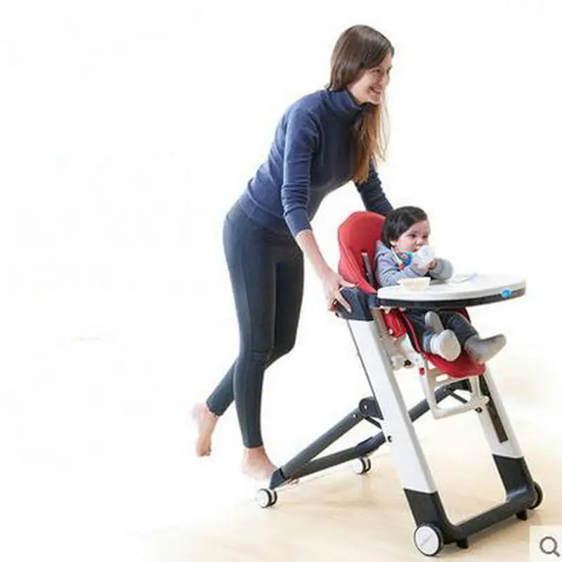 Woman adjusting a baby in a high chair with a white background