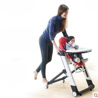 Woman adjusting a baby in a high chair with a white background