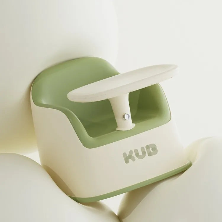 Green and white baby seat with 'KUB' branding on a light background