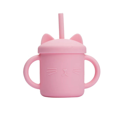 Pink sippy cup with cat ears and a straw on a white background