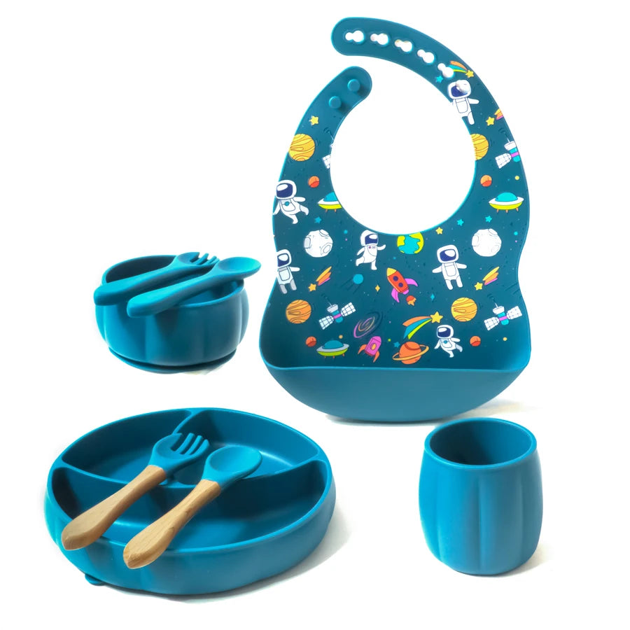 Blue children's dining set with bib, bowl, cup, and utensils on a white background