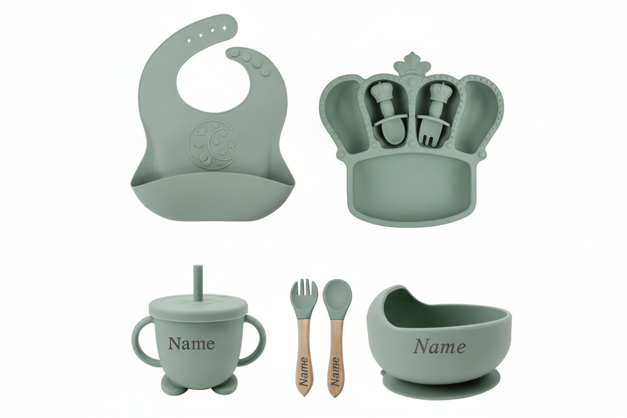 Set of green baby utensils  on a light gray background