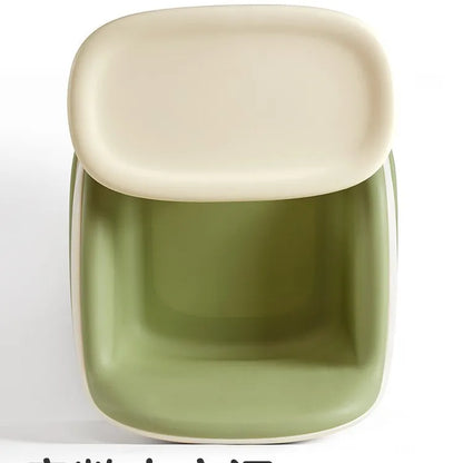 Green and beige square dish on a white background