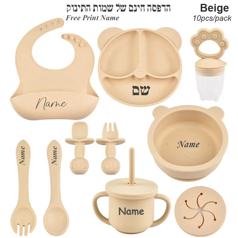 Beige baby utensil set with various items including a bib, bowl, cup, and more on a white background.