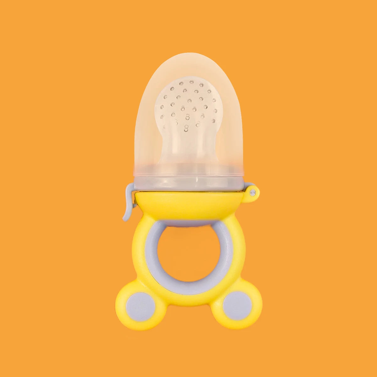 Yellow and clear baby pacifier on an orange background