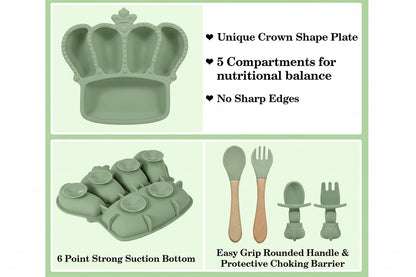 Children's dining set with crown-shaped plate, utensils, and suction base on a green background.