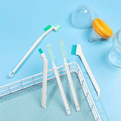Set of baby bottle cleaning brushes on a blue background with a bottle and cup.