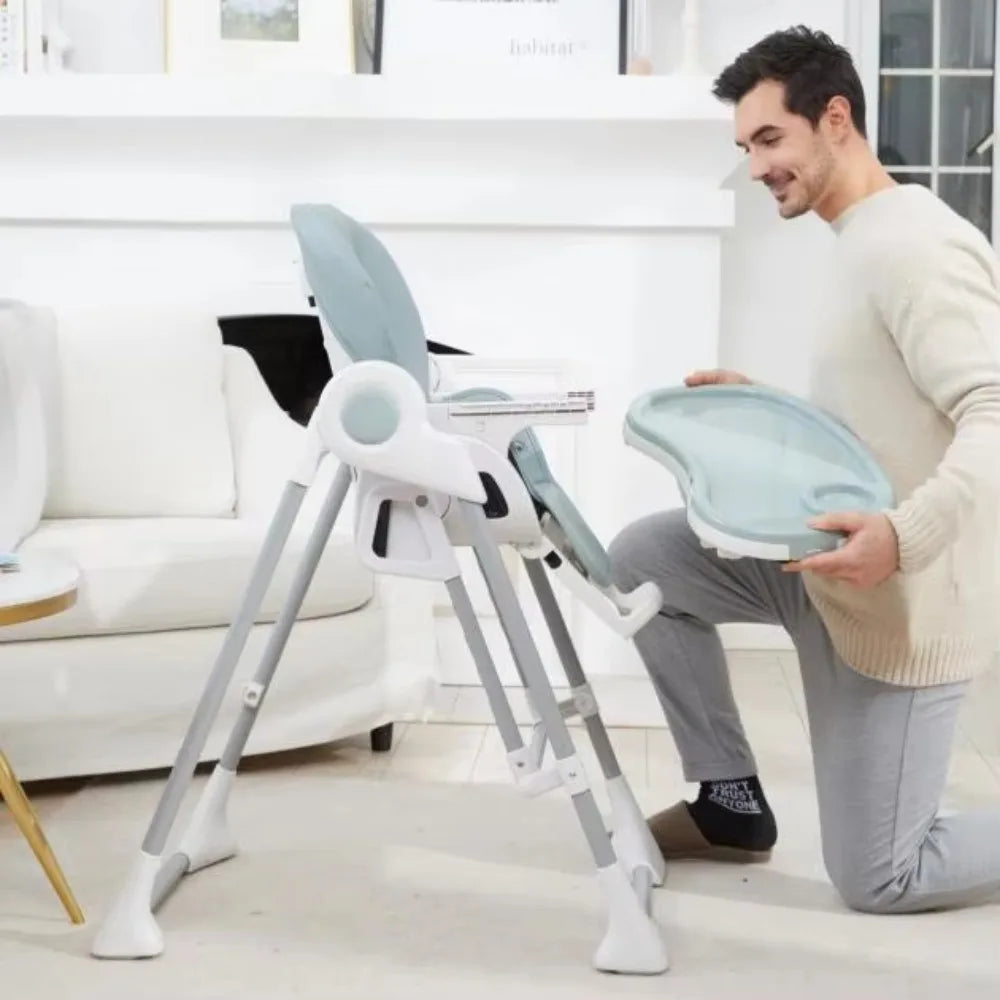 Man setting up a baby high chair in a living room.