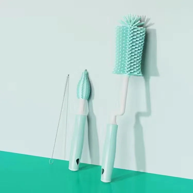 Set of dental cleaning tools including a brush, tongue cleaner, and scrubber on a light blue and green background.