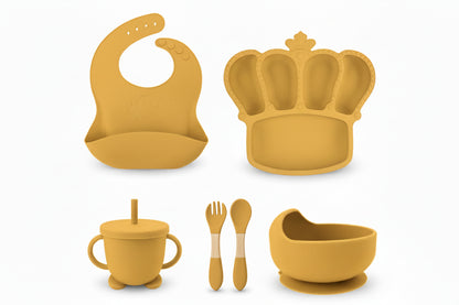 Yellow baby feeding set with customizable name on various items against a white background.