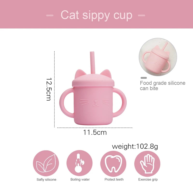 Pink cat-shaped sippy cup with measurements and features on a white background