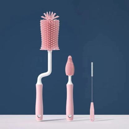Set of three pink cleaning brushes on a blue background