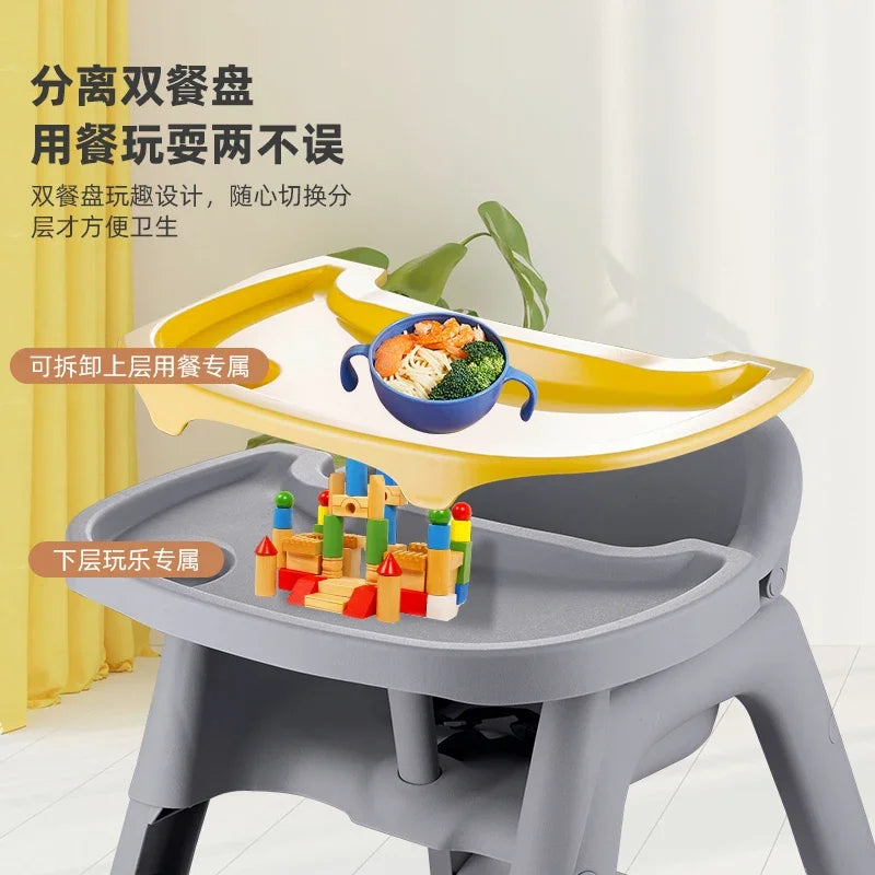 Children's activity table with a yellow tray and gray base, featuring food and toys on a white background.