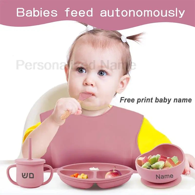 Baby sitting in a high chair with feeding utensils and a pink bib, with text overlay.