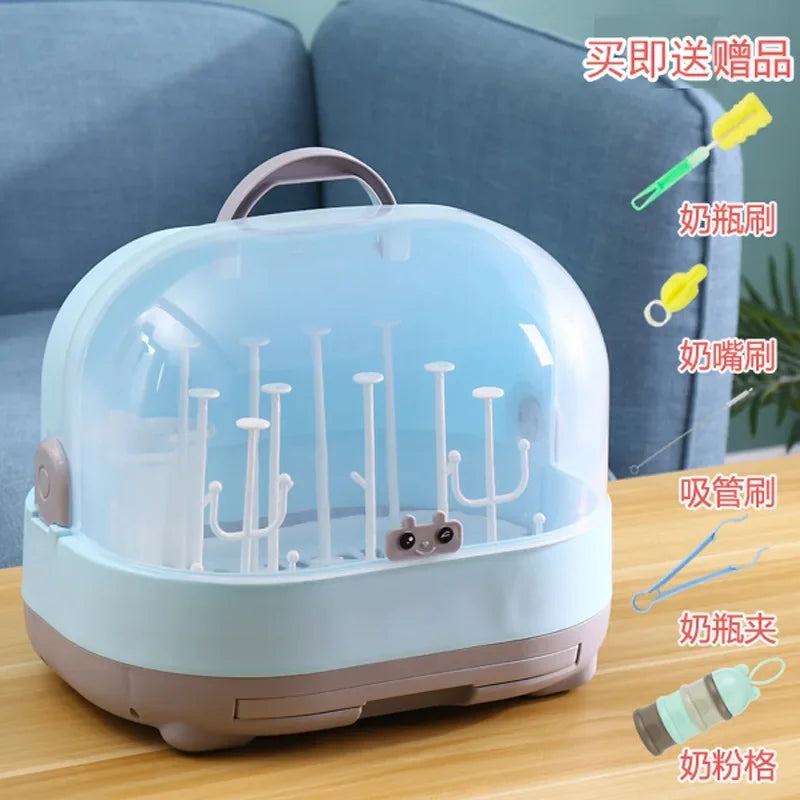Baby bottle sterilizer on a wooden surface with accessories displayed.