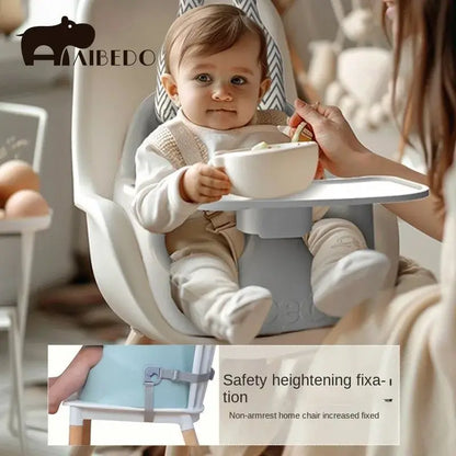 Baby sitting in a high chair with a bowl, being fed by an adult, with AIBEDO branding.