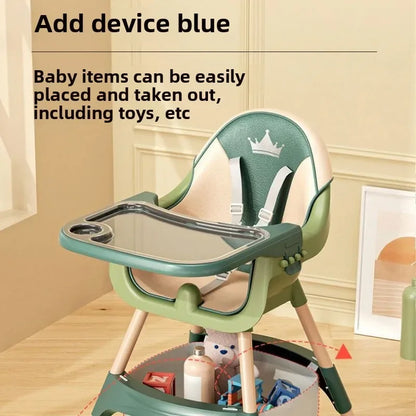 Green baby high chair with tray on a wooden floor