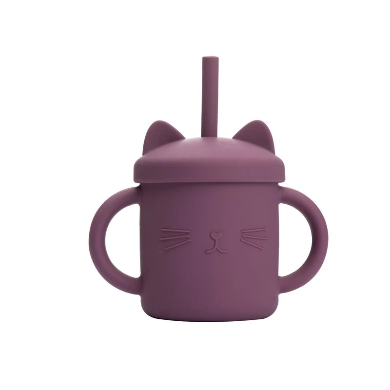 Purple children's sippy cup with cat ears and face design on a white background