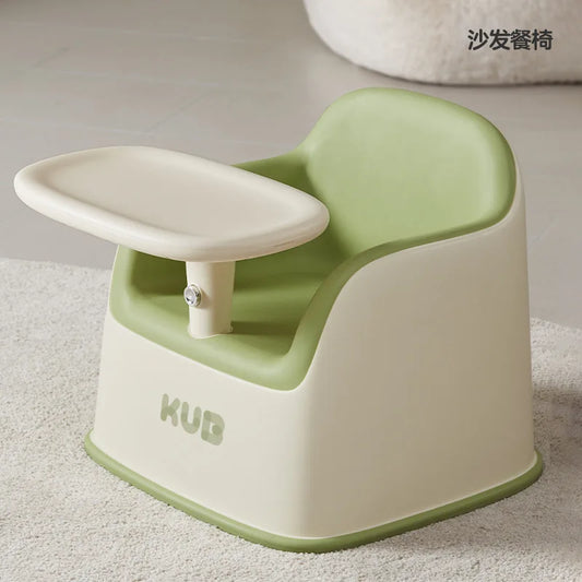 Green and beige baby seat with 'KUB' branding on a light background